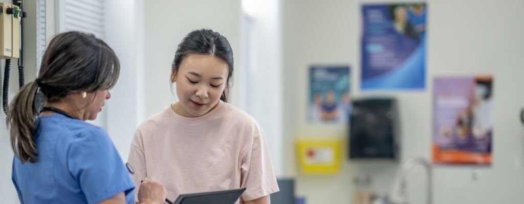 Woman speaking with a healthcare provider at Corbella clinic.